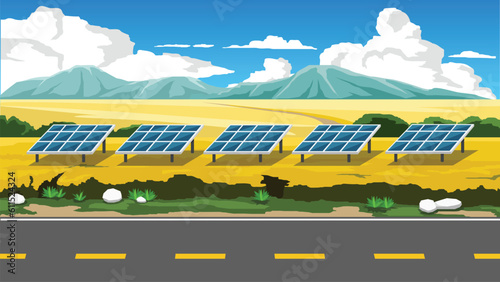 Horizontal view of asphalt road cuts through a vast field of yellow flowers. Solar panels lined up on the open area receive sunlight. Background of mountain under blue sky and white clouds.