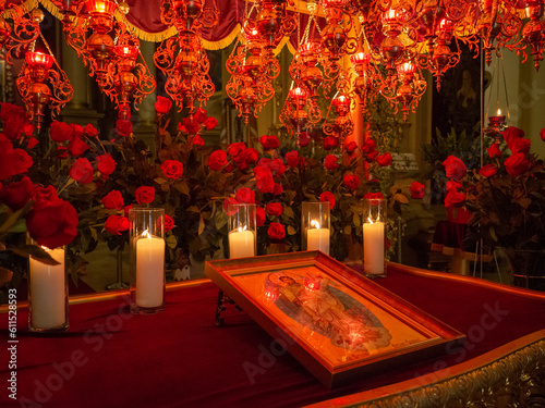 candles lighting on the red alter with icon of St. George cathedral in lviv old city photo