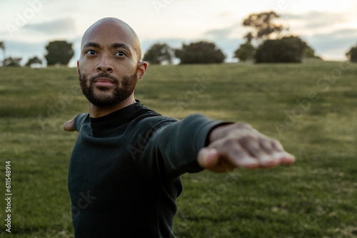 Young, Black man warrior pose 2 yoga, outdoor park, fitness and workout photo