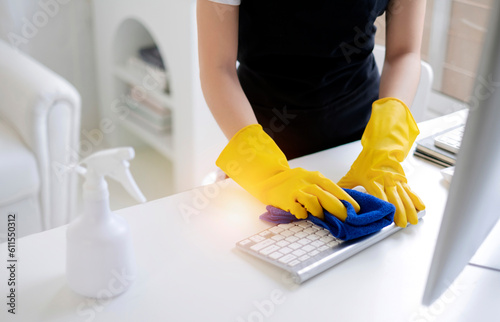 Cleaning Service concept. Cleaners employee removing dirt with equipment in office. Wiping office with cloth and liquid.