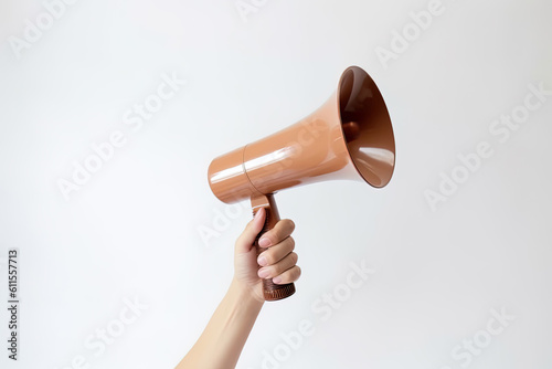 The hand holds a brown megaphone on a white background. Announcement concept. Shout It Out