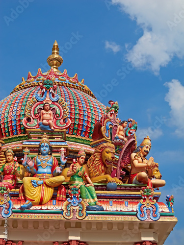 Hindu temple, Sri Mariamman and blue sky of history, culture and religion architecture in Singapore. Background, indian faith and worship, prayer or spiritual sign of building design, art and roof