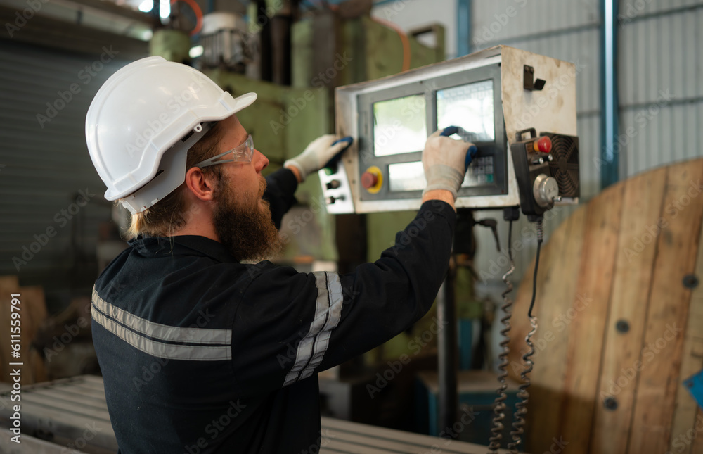 Portrait of mechanical engineers are checking the working condition of an old machine that has been used for some time. In a factory where natural light shines onto the workplace Portrait of mechanical engineers are checking the working condition of an old machine that has been used for some time. In a factory where natural light shines onto the workplace
