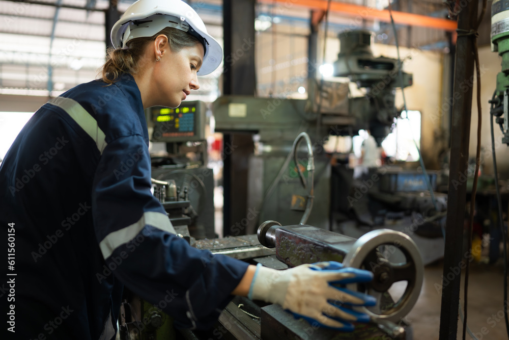 Portrait of mechanical engineers are checking the working condition of an old machine that has been used for some time. In a factory where natural light shines onto the workplace Portrait of mechanical engineers are checking the working condition of an old machine that has been used for some time. In a factory where natural light shines onto the workplace