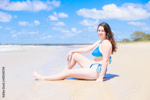 ビーチに座るセクシーな水着姿の白人の女の子 © photok