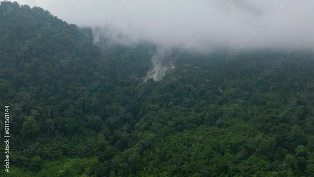 The slope of the active Sibayak volcano among the jungle and tropical forest. Mountain landscape in the tropics. Sumatra, Indonesia. The slope of the active Sibayak volcano among the jungle and tropical forest. Mountain landscape in the tropics. Sumatra, Indonesia.