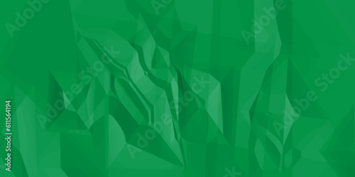 Crumpled green paper texture. Sheet of crumpled green paper as background, top view.  The green paper background is wrinkled, creating a rough texture with light and shadow.