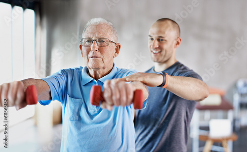 Physiotherapist, senior man and rehabilitation with dumbbells, fitness and exercise for recovery, help and training. Mature male person, client or employee with equipment, physical therapy and health