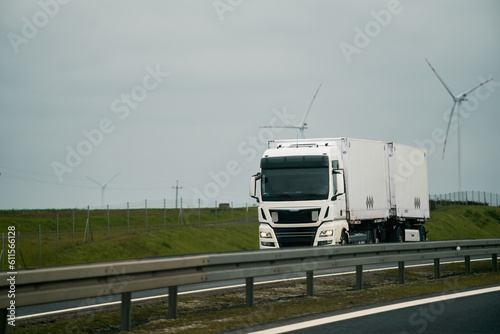 Wallpaper Mural A big truck moves on the highway concept of the shipping company. Landscape with a moving European semi truck Torontodigital.ca