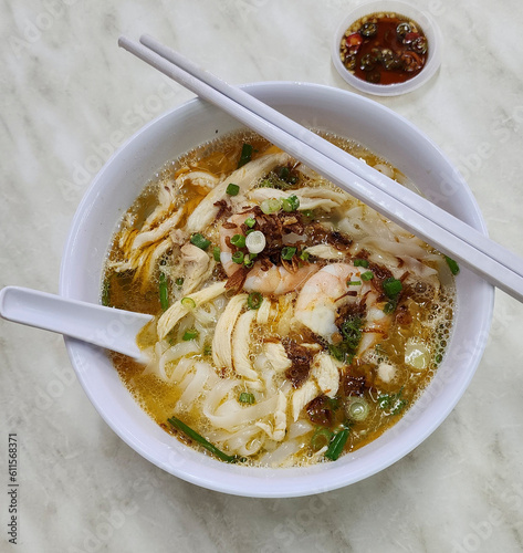 Famous street food. Ipoh Kai Si Hor Fun aka Shredded Chicken Prawn Flat Rice Noodle Soup. Soft smooth flat rice noodle in rich broth, shredded chicken meat, prawn, fried onions and cut chili soy sauce