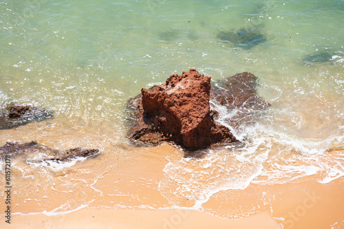 Top View of red rock in Turquoise blue Ocean. 