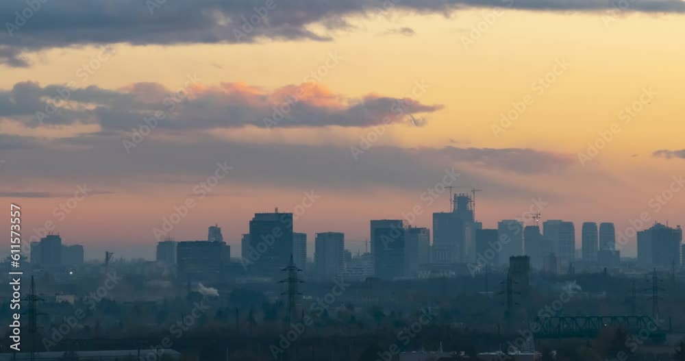 Cityscape sunset time lapse. The silhouettes of skyscrapers and urban buildings against the background of clouds. City modern intensive life. Cityscape sunset time lapse. The silhouettes of skyscrapers and urban buildings against the background of clouds. City modern intensive life.