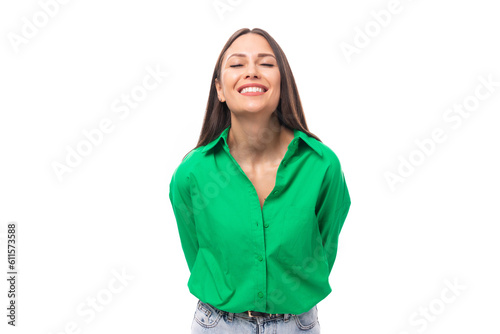smiling kind well-groomed slim european young brunette woman with makeup in a green shirt on a white background with copy space for banner © Ivan Traimak