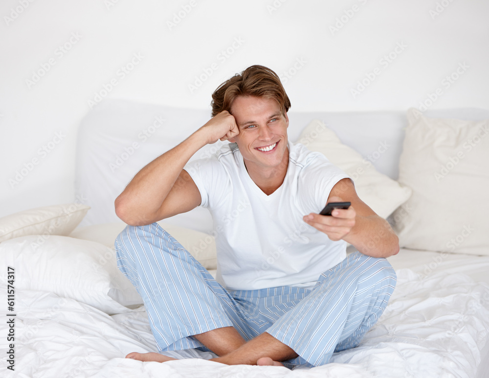 Man, smile and watching tv on a bedroom bed feeling relax with remote in the morning. Happy, video and young male person with series and movie with control in a house with television show at home Man, smile and watching tv on a bedroom bed feeling relax with remote in the morning. Happy, video and young male person with series and movie with control in a house with television show at home