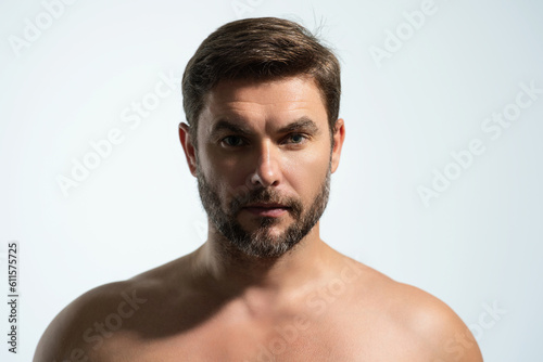 Cosmetics, body care and spa treatment. Portrait of masculinity charming shirtless man isolated over white background. Close-up portrait of attractive guy.