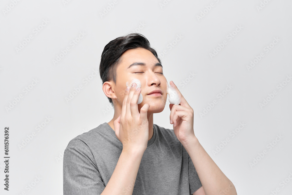 young man washing his face with cleansing foam, men's skincare concept young man washing his face with cleansing foam, men's skincare concept