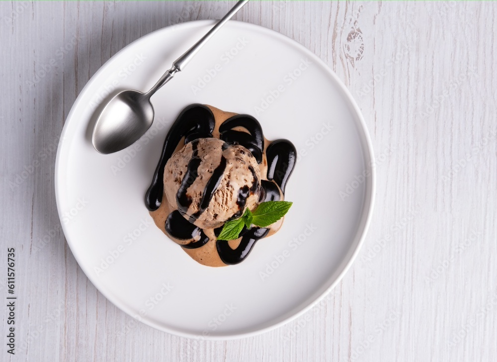 Chocolate ice cream ball and chocolate sauce isolated Chocolate ice cream ball and chocolate sauce isolated