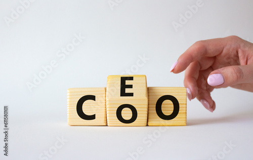 CEO and COO symbol. Businessman hand turns wooden cubes and changes word CEO to COO. Beautiful white background. CEO and COO and business concept. Copy space