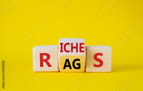 Rags vs Riches symbol. Wooden cubes with words Rags and Riches. Beautiful yellow background. Rags vs Riches and business concept. Copy space