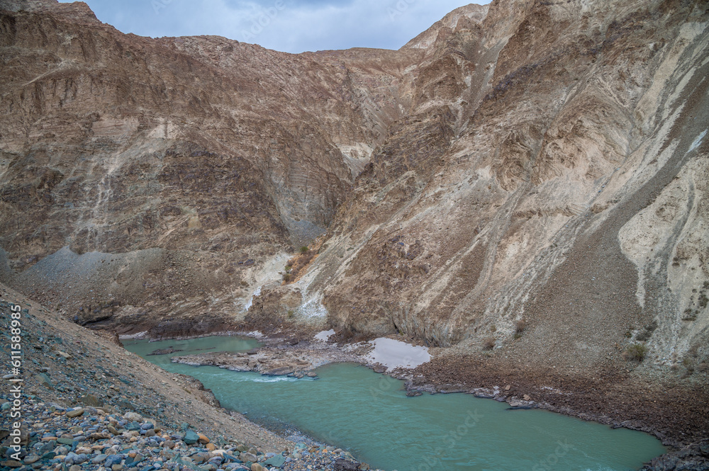 Zanskar mountain river valley Ladakh India with scenic landscape. Green color Zanskar river between two mountain Peaks, Valley view in Ladakh. Panoramic view of the River on the Roadside