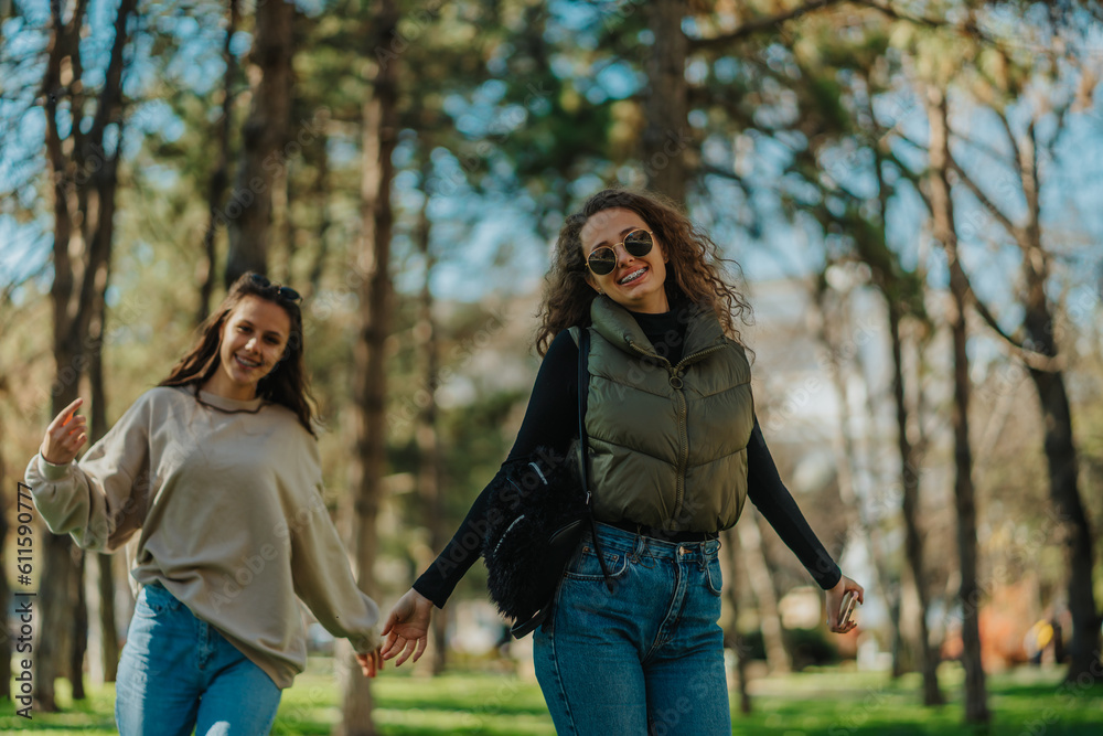 Smiley, overjoyed girls hanging out in the park. They are looking at the camera Smiley, overjoyed girls hanging out in the park. They are looking at the camera