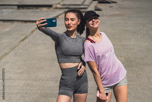 20s sportsgirls taking a selfie before training out in the city photo