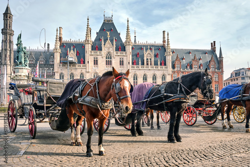 Horses on Grote Markt Brugge, the main attraction of Bruges, Belgium