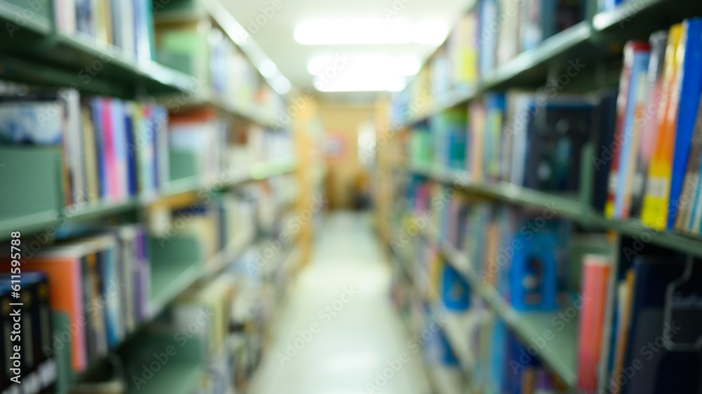 Blurred public library interior with aisle of bookshelf with textbooks and literature. Education, knowledge learning and background Blurred public library interior with aisle of bookshelf with textbooks and literature. Education, knowledge learning and background