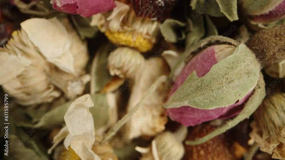 Essential herbs and flowers for tea, including chamomile and rose, scattered in a mix. Dolly slider extreme close-up. Essential herbs and flowers for tea, including chamomile and rose, scattered in a mix. Dolly slider extreme close-up.
