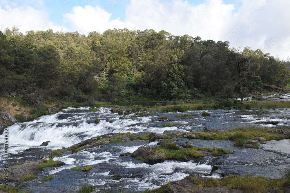 River flowing with green hills and blue sky River flowing with green hills and blue sky