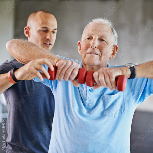 Physiotherapist man, senior patient and weight training for health and wellness therapy in retirement. Healthcare, physio and workout for recovery with a dumbbell for medical care and elderly person