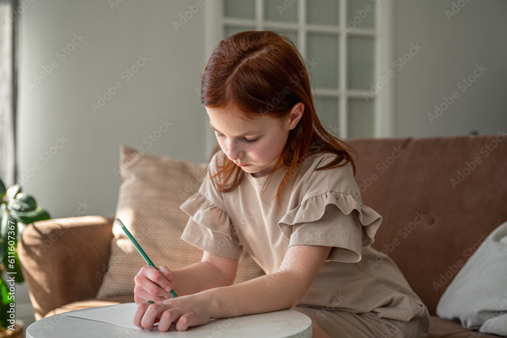 cute little preteen girl drawing with pen while sitting at desk at home, beautiful female child, small kid doing school homework cute little preteen girl drawing with pen while sitting at desk at home, beautiful female child, small kid doing school homework