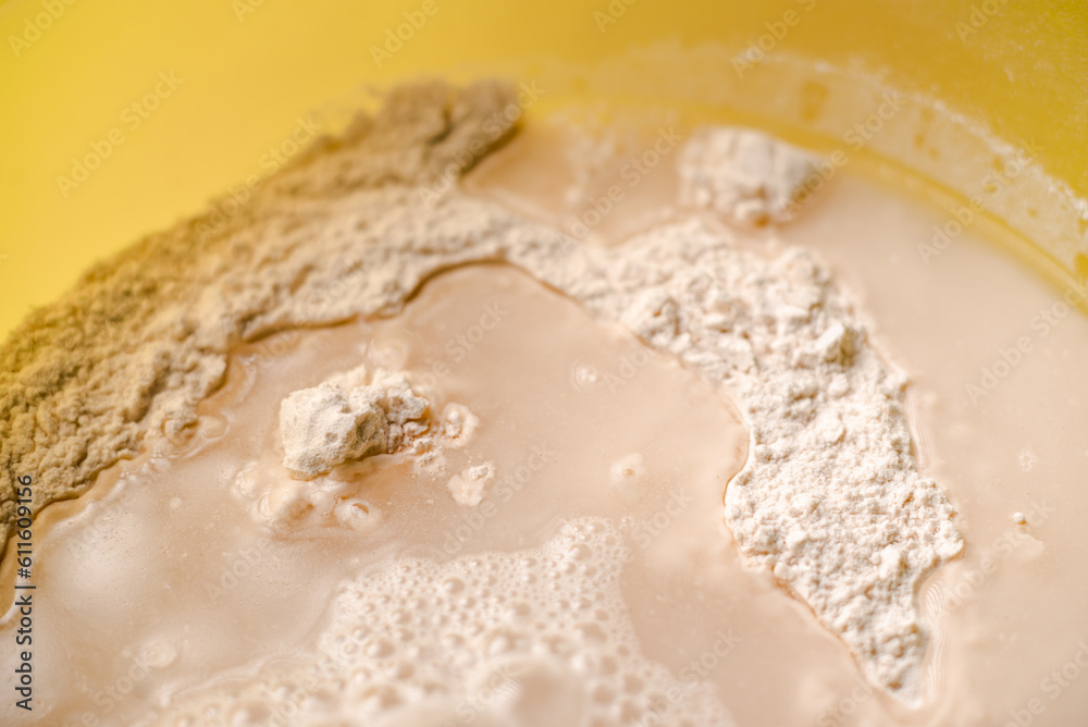 Mixing flour, dry yeast and water. Cooking dough for bread or pizza close-up. Mixing flour, dry yeast and water. Cooking dough for bread or pizza close-up.