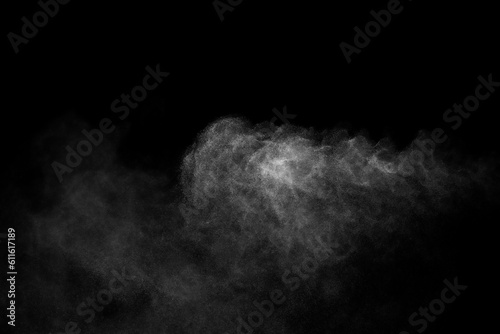 Close-up of steam or abstract white smoke rising above. from humidifier spray isolated on a black background