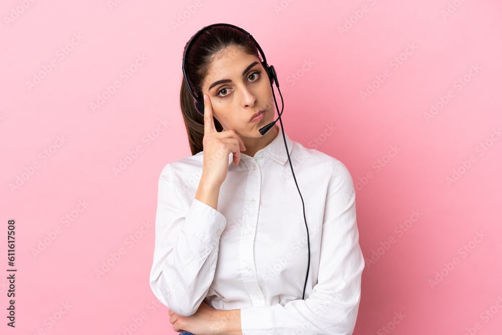Young telemarketer over isolated background thinking an idea Young telemarketer over isolated background thinking an idea