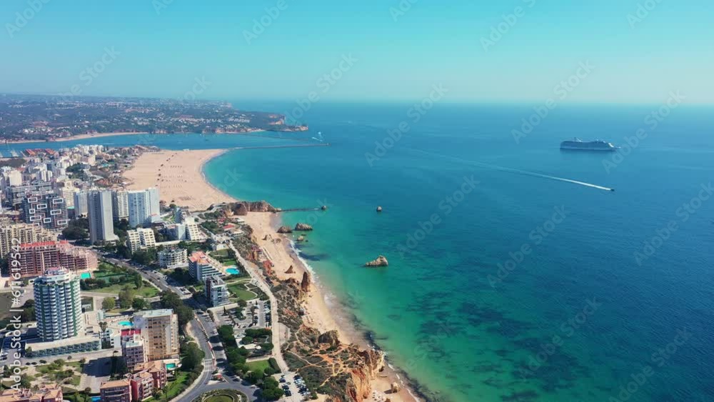 Tourist Portuguese city of Portimao aerial view on a sunny day. South Portugal Algarve. At sea, a cruise tourist liner. Tourist Portuguese city of Portimao aerial view on a sunny day. South Portugal Algarve. At sea, a cruise tourist liner.