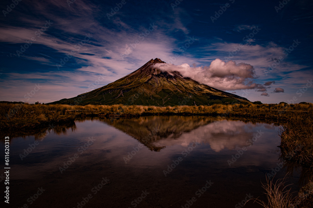 Fototapeta premium New Zealand, Mount Taranaki is the symmetrical volcanic cone that rises from sea level to 8,260 ft (2,518 m). This mountain is located in Egmont National Park, North Island of the New Zealand.