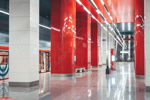 Canvas Print Moscow, Russia - 8 June 2023: Moscow metro station in red colors and a train standing at the platform