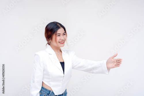 A friendly young woman holding her hand out to offer a handshake on the right side. Isolated on a white background.