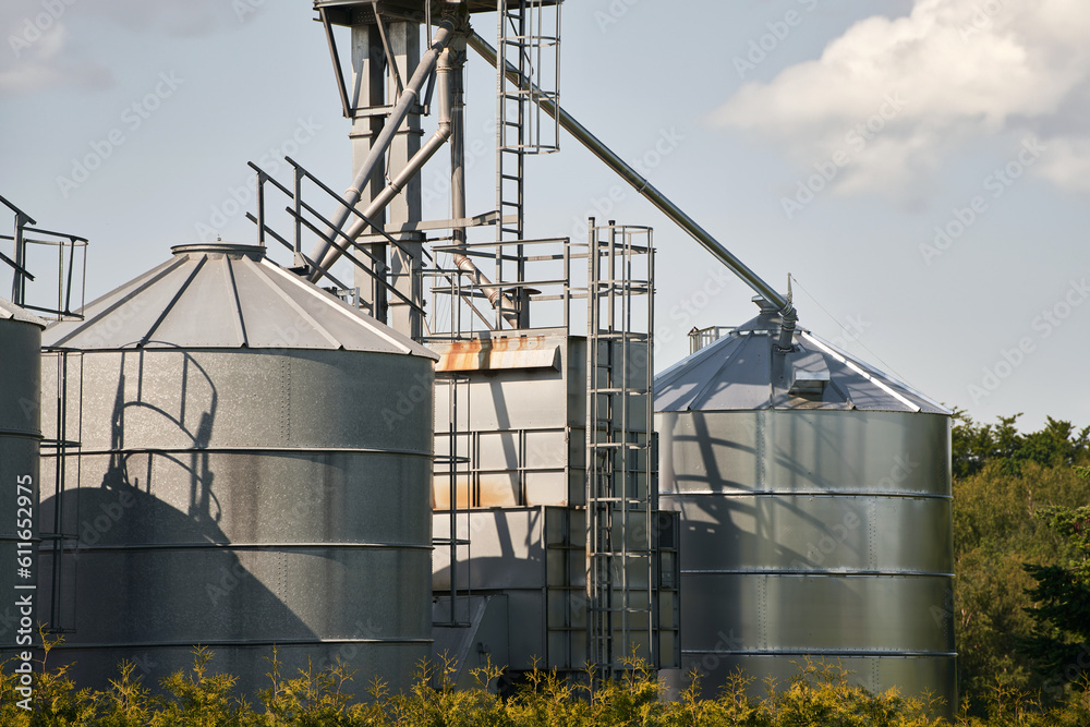 Agribusiness landscape. Steel Agricultural Silos - Building Exterior, Storage and drying of grains, wheat, corn, soy and sunflower