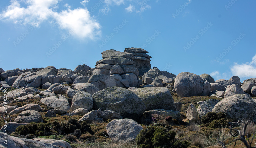 Huge granite rock that surrounds Volax village in Tinos island Cyclades Greece. Summer day blue sky