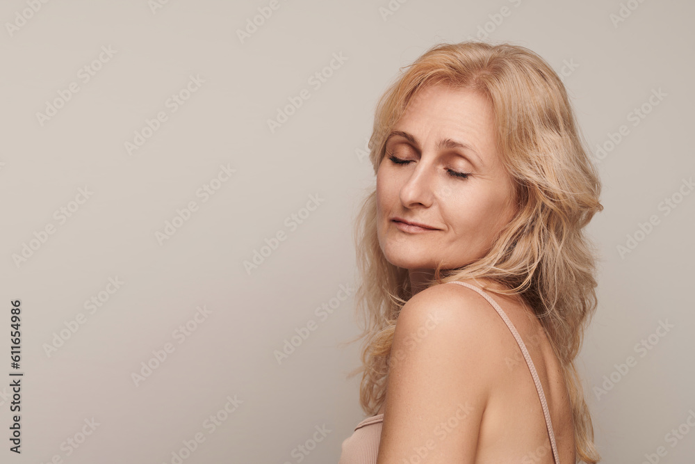 Beautiful blond middle aged woman smiling face closed eyes portrait. Elegant mature lady no makeup 50 years old close-up isolated on white. Women's health, cosmetology, skin care Beautiful blond middle aged woman smiling face closed eyes portrait. Elegant mature lady no makeup 50 years old close-up isolated on white. Women's health, cosmetology, skin care