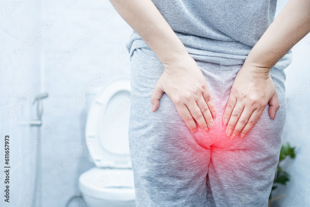 woman suffering from hemorrhoids hurting and bleeding during bowel
