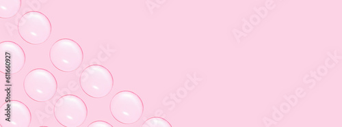 Drops of clear gel or water in rows. On a pink background. © MM
