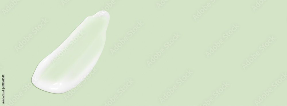 The flowing cream on a green background. Smudged flowing smear of cosmetic cream. The flowing cream on a green background. Smudged flowing smear of cosmetic cream.
