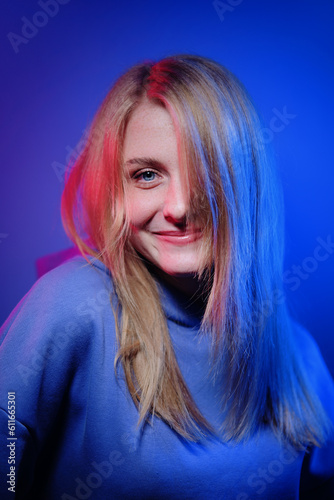 Colorful studio portrait of a happy young woman with a blonde hair