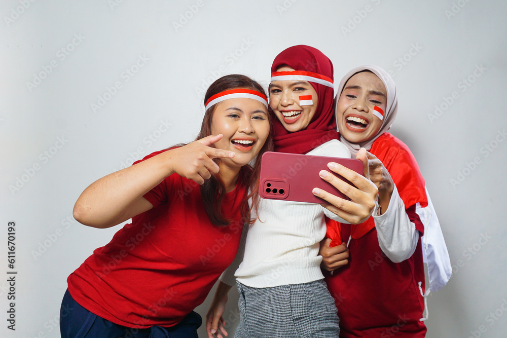 happiness of a group of young people using the red and white attributes to commemorate independence day happiness of a group of young people using the red and white attributes to commemorate independence day