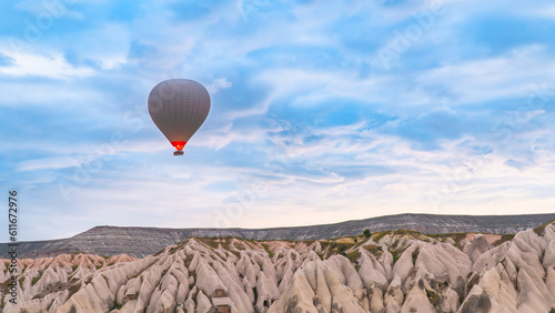 Cappadocia. Hot air balloons flying over Cappadocia in a dramatic sky. Travel to Turkey. Selective focus included.