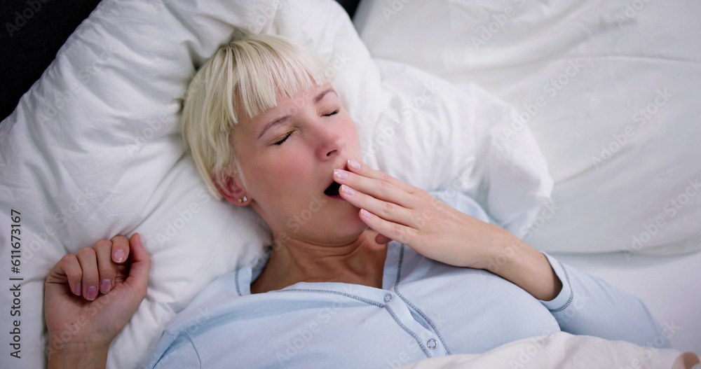 Young Woman Yawning In Bed Young Woman Yawning In Bed