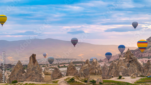 Cappadocia. Hot air balloons flying over Cappadocia in a dramatic sky. Travel to Turkey. Selective focus included.